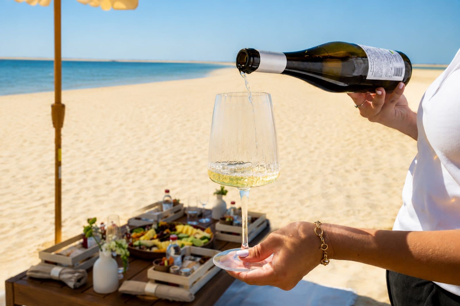 White wine being poured at the picnic table