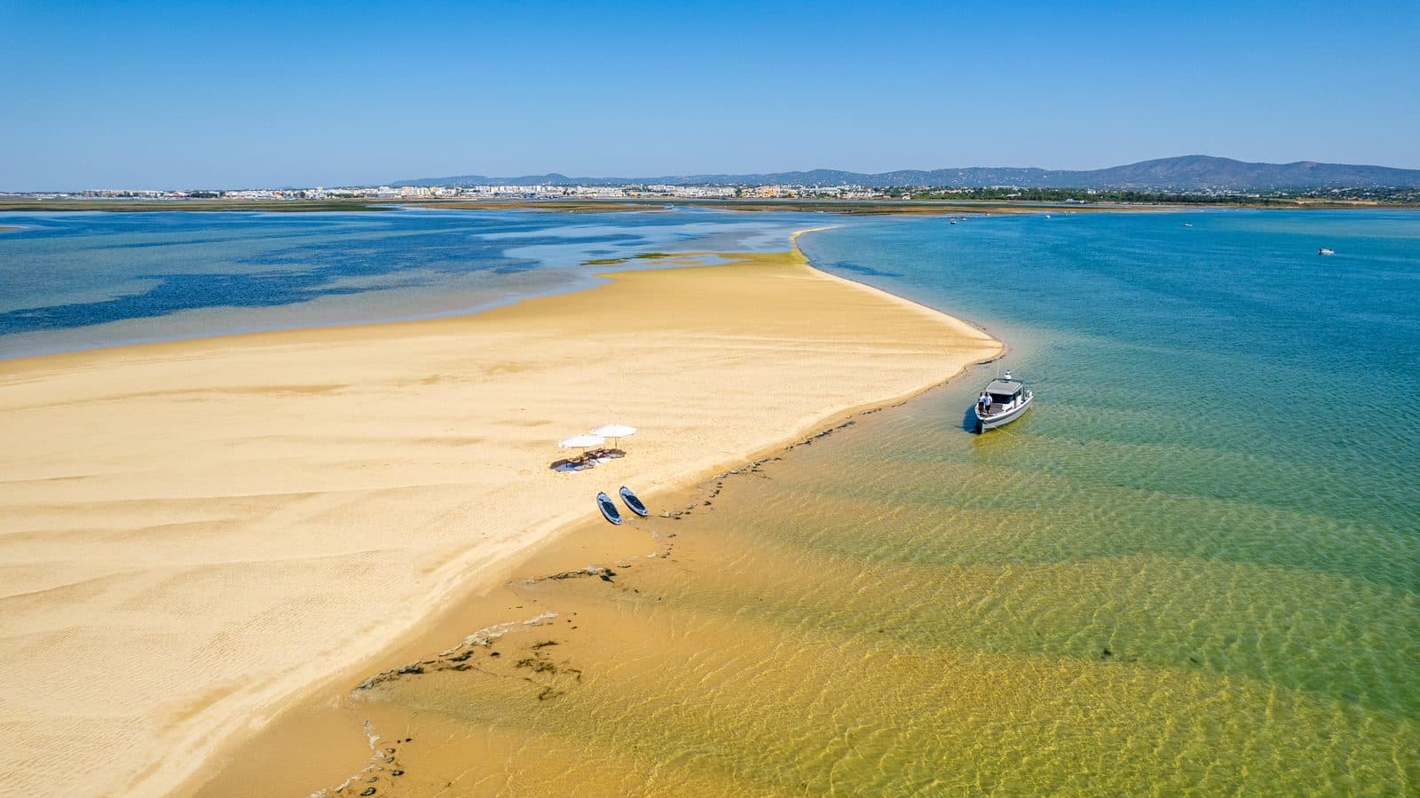 Aerial view of Arkeo, the parasols and the paddle boards on a sandbank